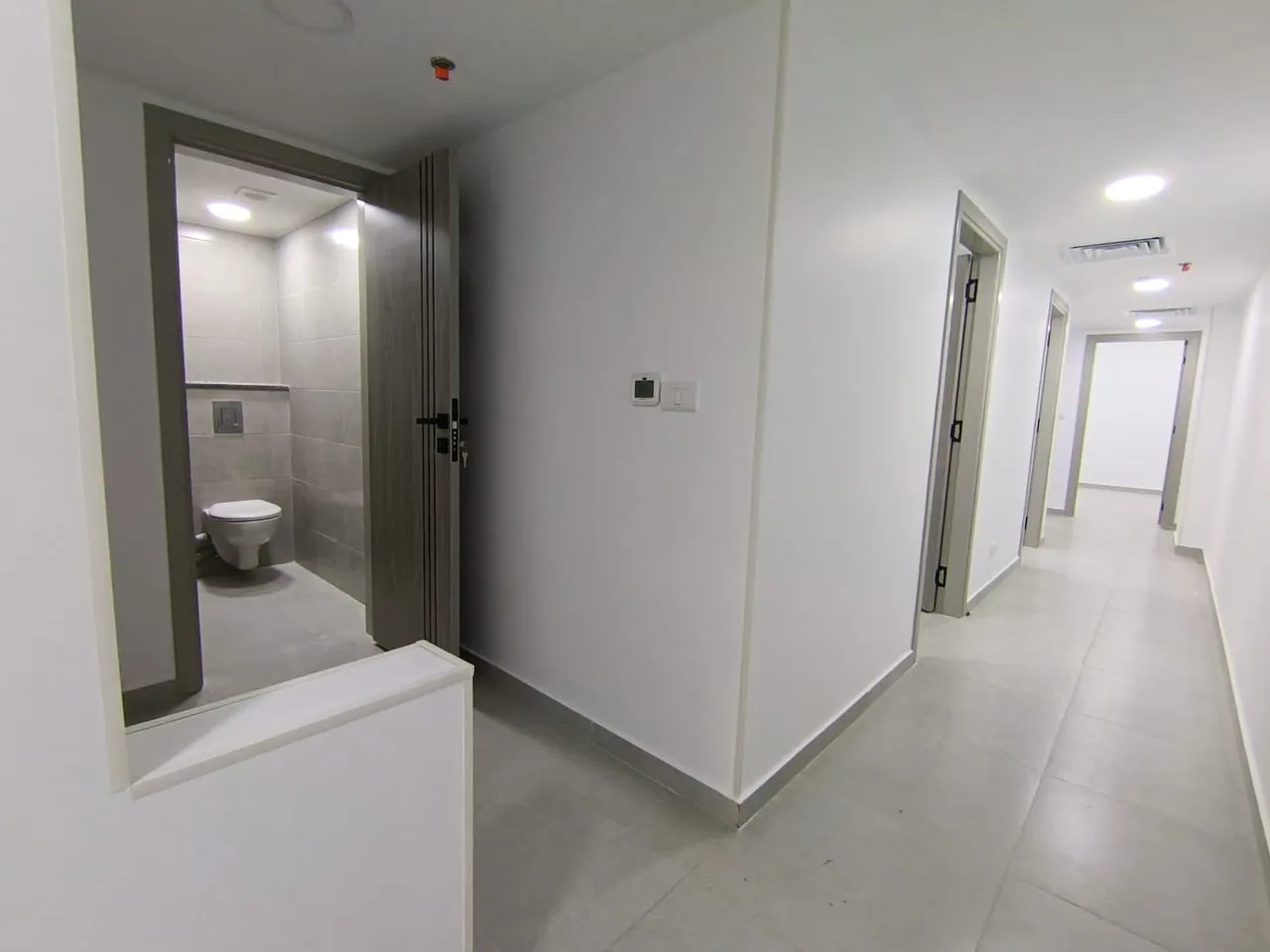 Corridor of finished rooms with a bathroom off it in a 160 m² clinic on the Maadi Corniche, Cairo