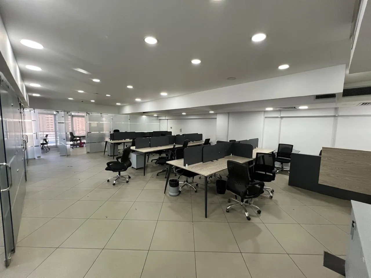 Open-plan office with rows of desks and a tiled floor in a full floor for rent in Bavaria Towers, Ring Road, Cairo