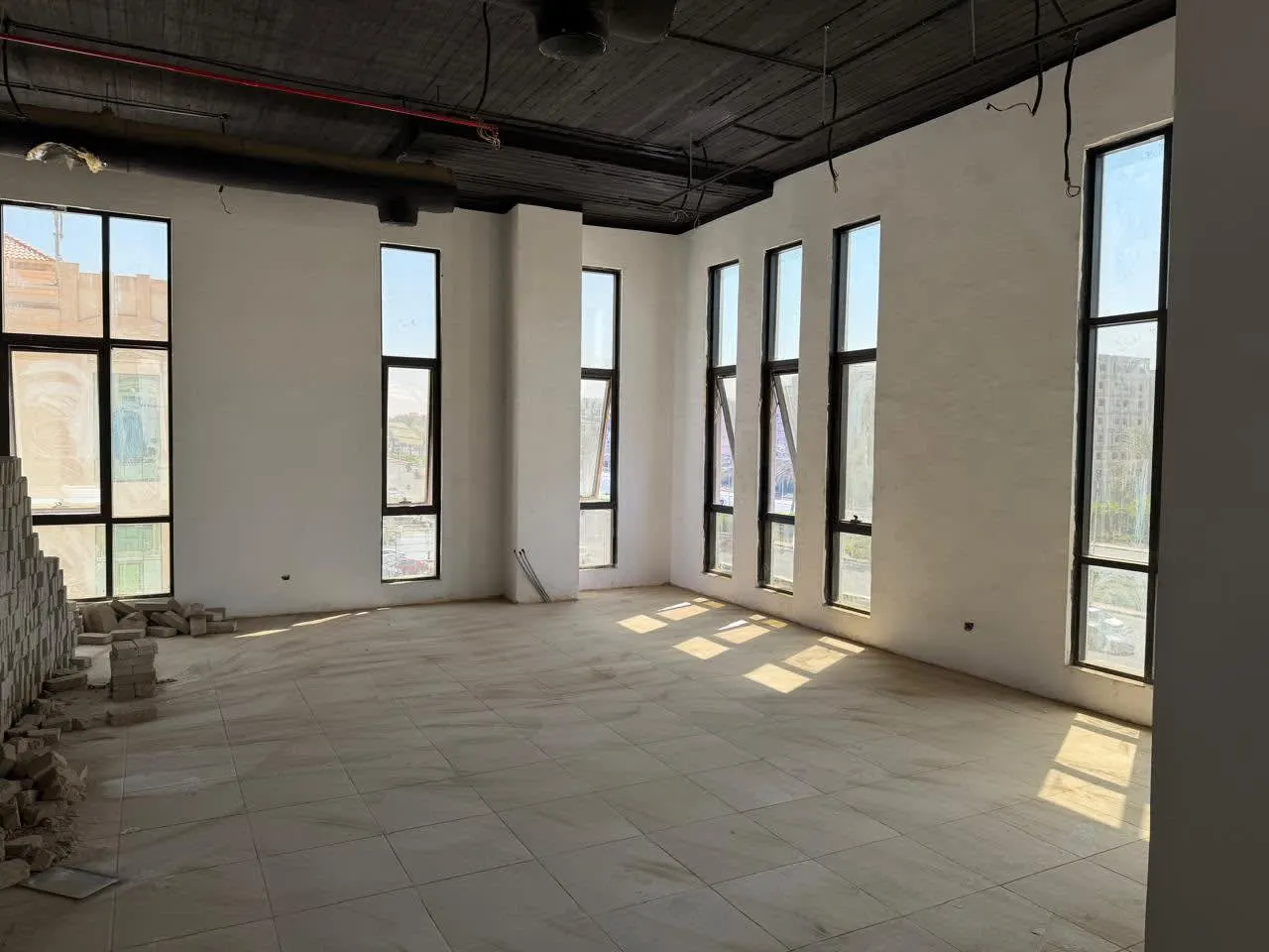 Bright open office space with full-height windows in a large administrative office for rent in First Settlement