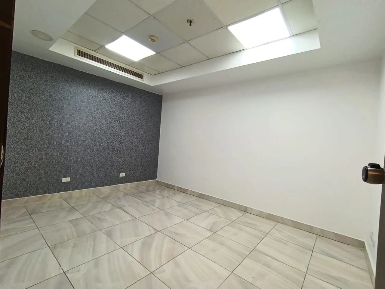 Finished clinic room with marble floors and a feature wall in a 245 m² clinic for rent in Maadi Corniche