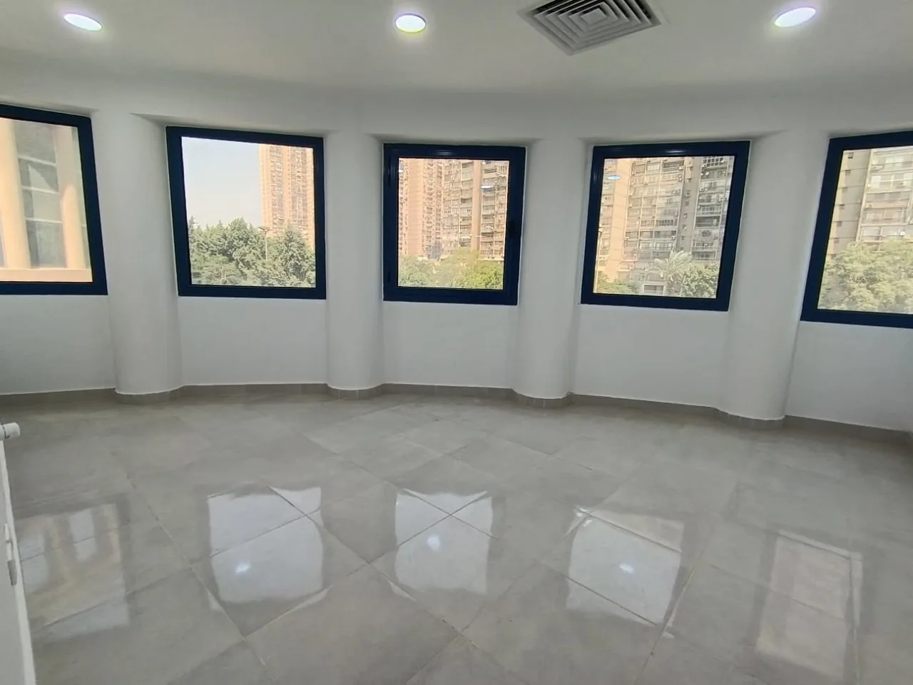 Bright clinic room with a wall of windows in a 90 m² clinic for rent in Maadi Corniche