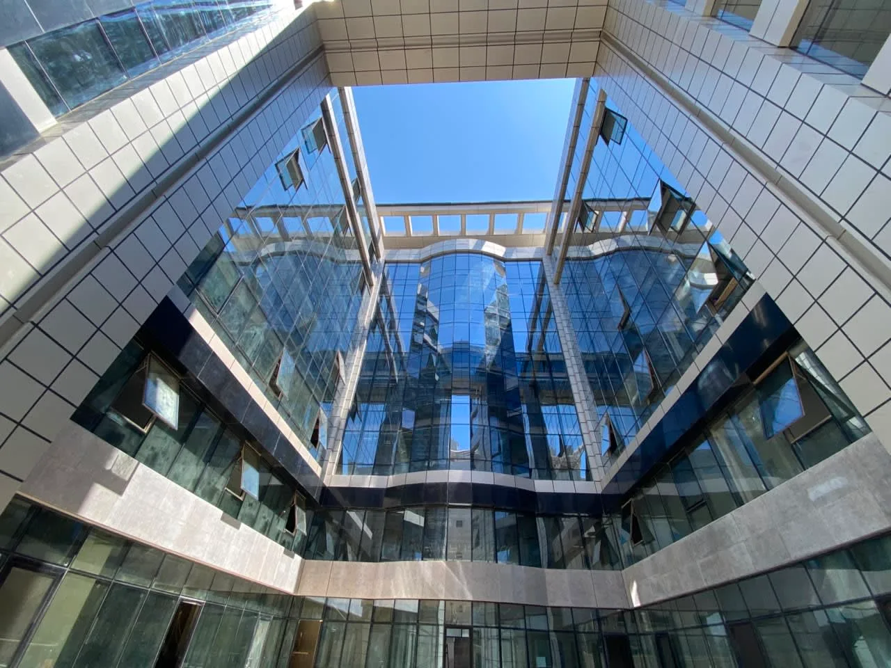 Open glass atrium rising through a whole administrative building on South 90th Street, New Cairo