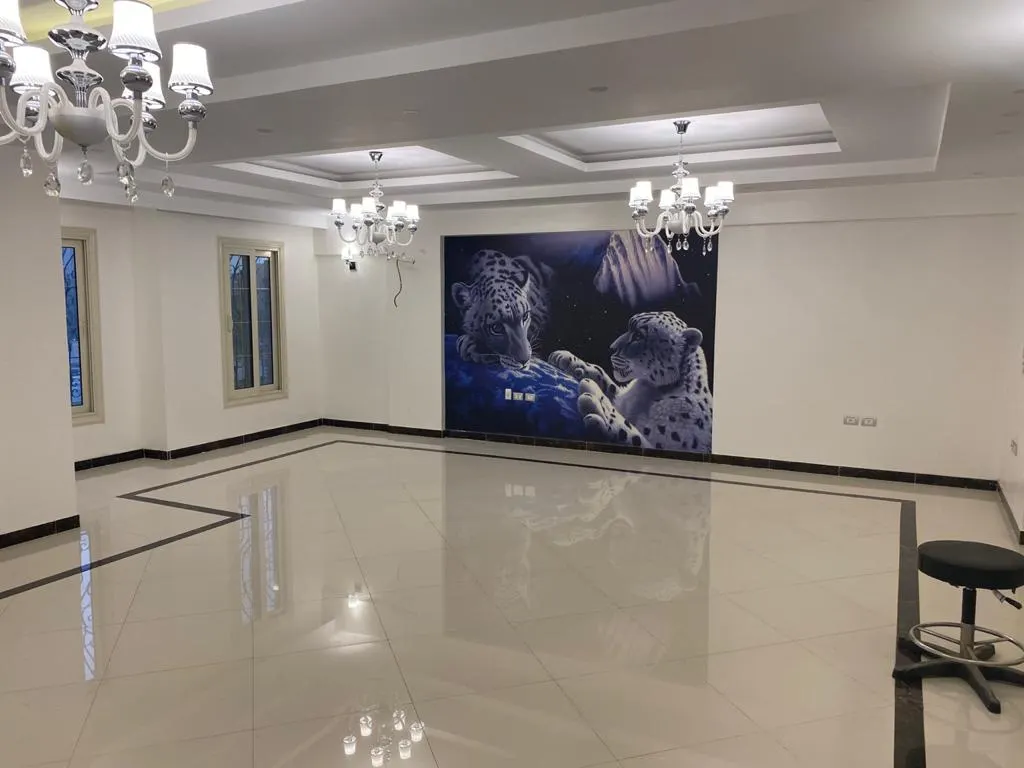 Wide marble reception hall with chandeliers and a leopard mural in a 430 m² penthouse in El Banafseg, New Cairo