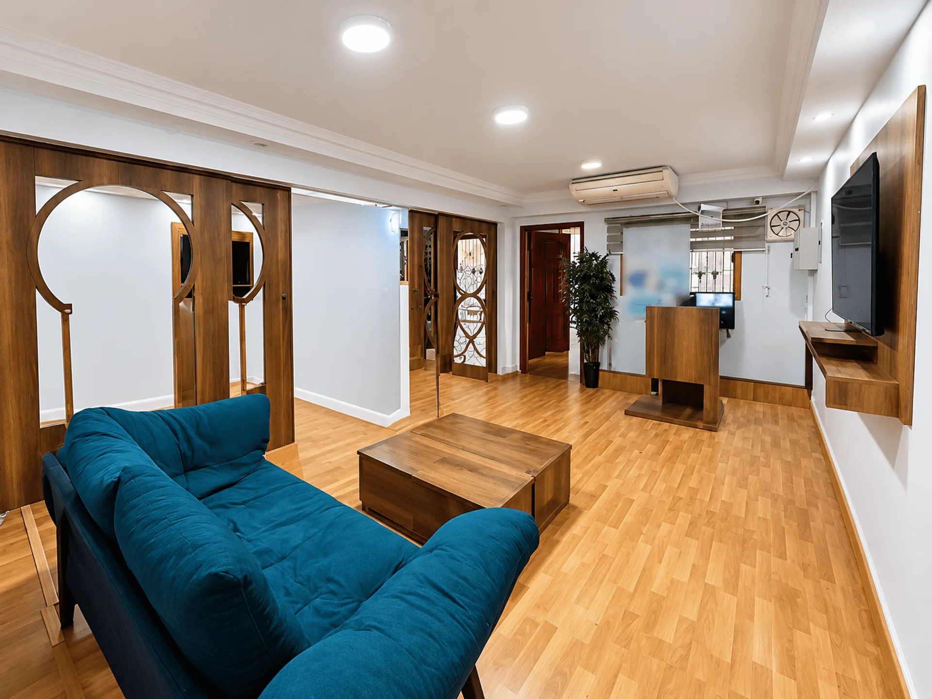 Waiting area with a teal sofa, wooden arches and a reception desk in a clinic for rent in Maadi, Cairo