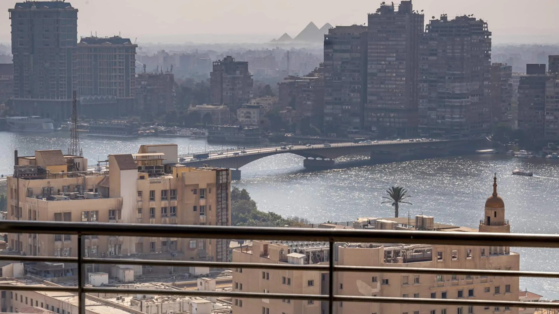 View of the Nile, a bridge and the Giza Pyramids from the balcony of a serviced apartment in Garden City, Cairo