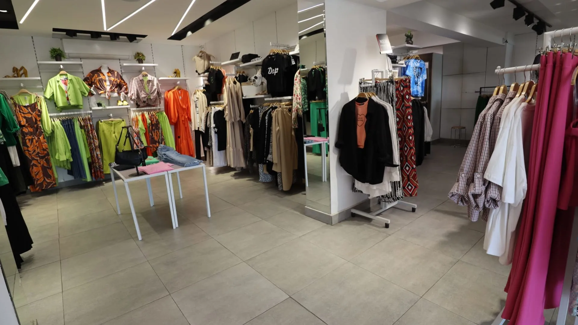 Clothing shop in Degla, Maadi with rails of garments and a tiled floor
