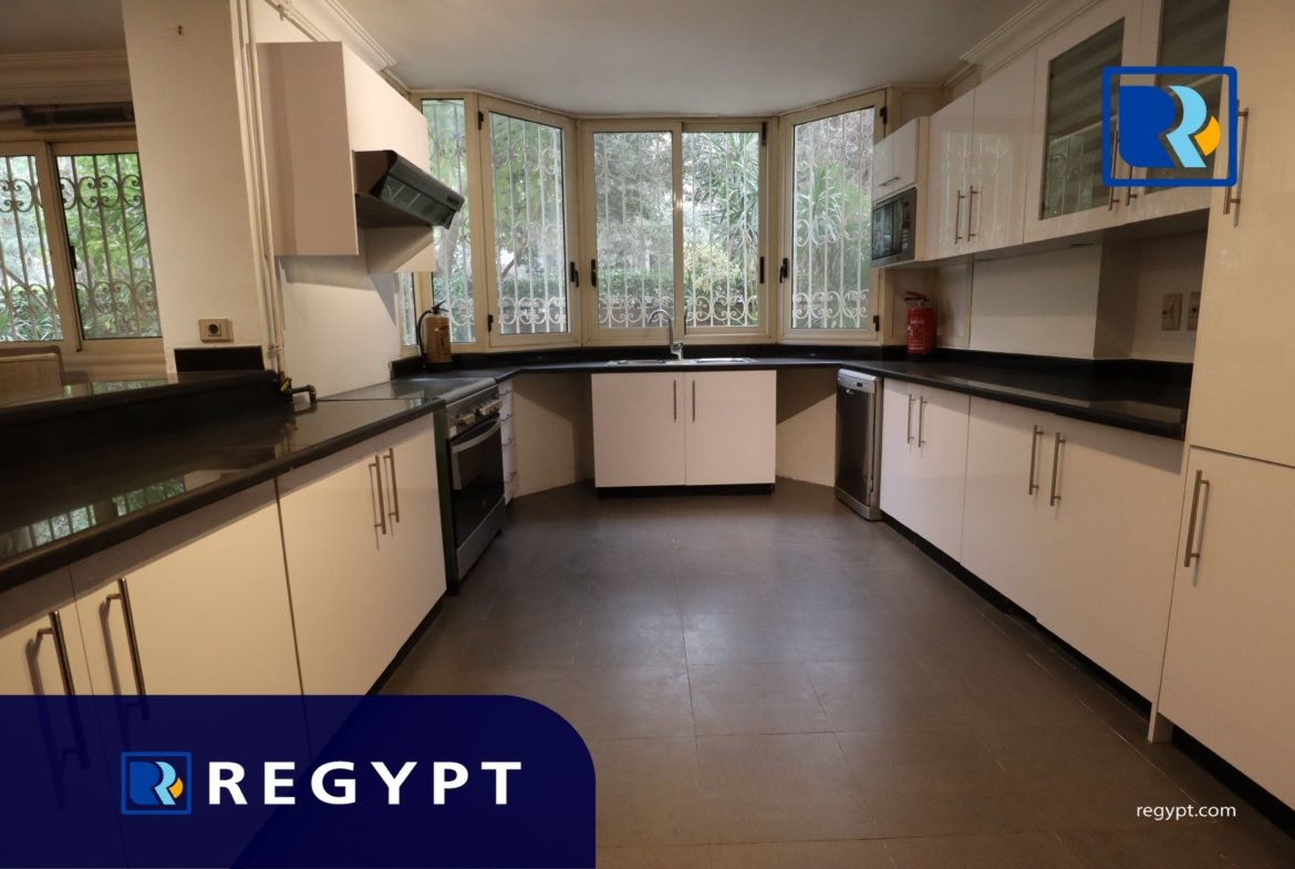 Kitchen full of appliances in a Ground Floor With Pool