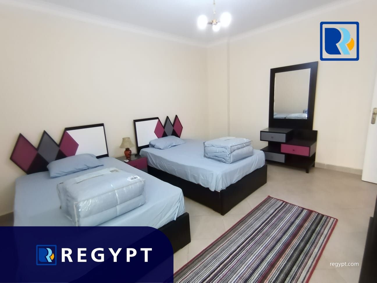 Bedroom with two small beds in a Fully equipped Apartment For Rent