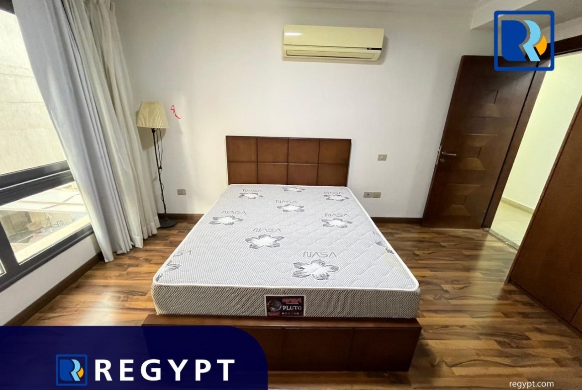 Bedroom with wooden floor in a Sunny Apartment For Rent In Maadi
