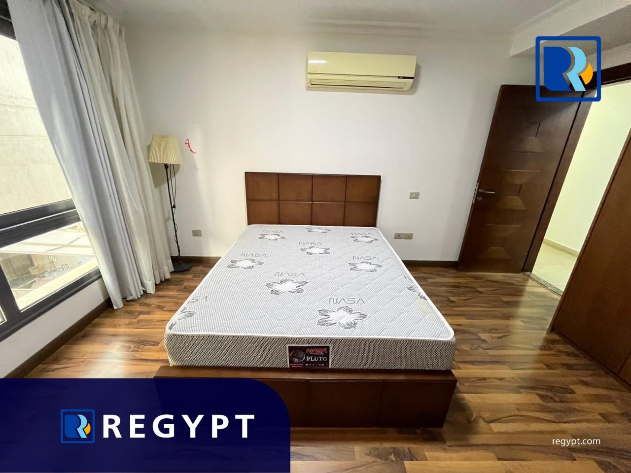 Bedroom with wooden floor in a Sunny Apartment For Rent In Maadi