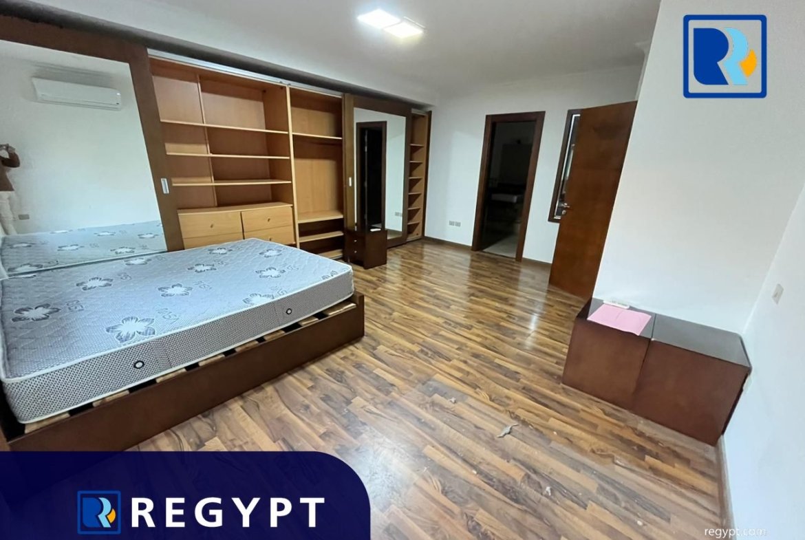 second bedroom with wooden floors in a Sunny Apartment For Rent In Maadi