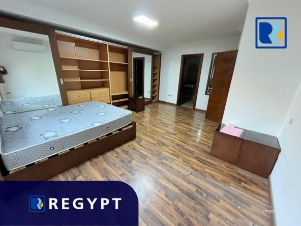 second bedroom with wooden floors in a Sunny Apartment For Rent In Maadi