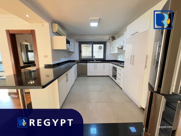 Kitchen full of appliances in a Sunny Apartment For Rent In Maadi